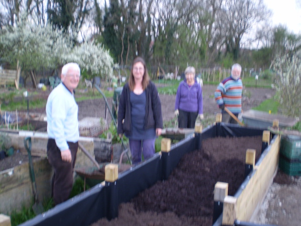 Picture of Dried of Barry, Rachael, Cath and Colin filling the beds with top soil and compost 